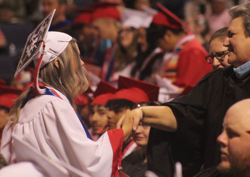 Brighton High School's Annika Cunningham is congratulated by Principal Shelly Genereux at commencement exercises May 25 at 1stBank Center in Broomfield.